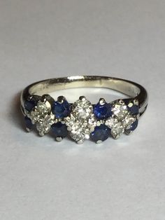 Gorgeous genuine sapphire and diamond band. It is 14k white gold. Total diamond weight is approx. 1/2cttw. There are 4-.05, 2-.10 and 6-.02 diamonds. There are 4-2.8mm and 4-1.8mm sapphires. Diamonds are SI quality and very sparkly. The sapphires do have some wear on them from age that can be seen with a jewelers loop. This ring would be great by itself, as a wedding band or a stackable. It weighs 3.4 grams. It is a size 6.5 and could be sized for an additional fee if needed. Any questions, plea Platinum Cluster Multi-stone Diamond Ring, Platinum Multi-stone Cluster Diamond Ring, Classic Blue Diamond Ring With Accents, Multi-stone Round Sapphire Ring In Platinum, Classic Cluster Sapphire Ring With Vvs Clarity, White Gold Multi-stone Round Sapphire Ring, White Gold Cluster Diamond Ring With Multi-stone, White Gold Multi-stone Diamond Ring Round Cut, White Gold Sapphire Ring With Multi-stone