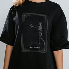 a woman wearing a black t - shirt with an image of a skeleton on it