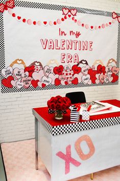 a valentine's day table with flowers and gifts on it