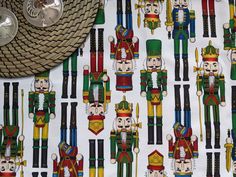 the nutcrackers are all different colors and sizes on this tablecloth with silverware