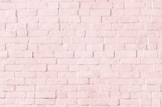 a pink brick wall with white bricks