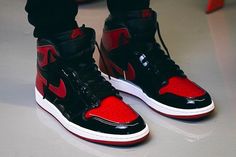 The Air Jordan 1 Retro High OG Patent ‘Bred’ treats the iconic colorway to a glossy makeover. Aside from the shoe’s patent leather construction . the essential design DNA remains intact. The upper pairs basic black paneling with contrasting hits of Varsity Red on the toe box . Swoosh . heel overlay and collar flap. [...] Air Jordan 1 Red, Jordan 1 Red, Jordan 1 Black, Nike Fashion Shoes, Jordan Shoes Girls, Jordan Shoes Retro, Nike Air Shoes, Jordan Air, Jordan 1 High Og