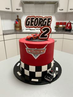 a red and black cake sitting on top of a table