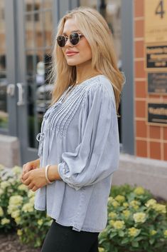 Bring a touch of texture and charm to your wardrobe with the Denim Tie Detail Textured Top, a perfect blend of casual and chic! Featuring elbow-length puff sleeves and a flattering V neckline, this top exudes a feminine silhouette. The delicate pin-tuck front panel adds a touch of detail, while the playful front tie detail enhances its boho flair. It is soft, breathable, and comfortable for all-day wear. Ideal for pairing with your favorite jeans or skirts, this top is a versatile piece that transitions effortlessly from day to night! Spring Casual Puff Sleeve Blouse, Chic Blouse For Casual Gatherings, Chic Day Out Blouse With Bishop Sleeves, Feminine Spring Blouse For Casual Gatherings, Chic Blouse With Bishop Sleeves For Day Out, Feminine Blouse For Casual Spring Gatherings, Chic Bishop Sleeve Blouse For Spring, Chic Bishop Sleeve Blouse For Day Out, Spring Peasant Top