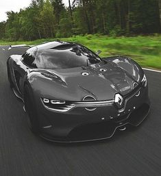 a black sports car driving down the road