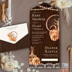 a baby shower is set up on a table next to some flowers and other items