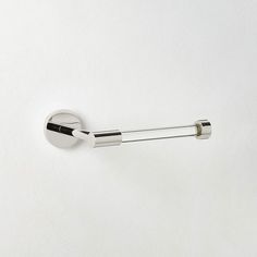 a chrome toilet roll holder on a white wall