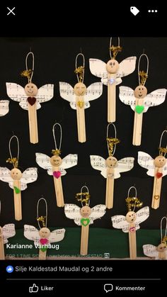 wooden pegs with angel ornaments attached to them on a black background, in the shape of angels