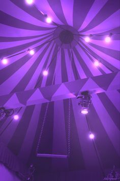 a purple and white striped ceiling with lights