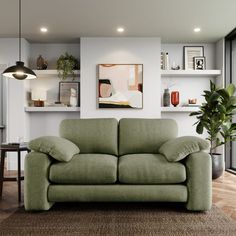 a green couch sitting in front of a window