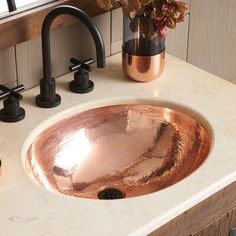 a bathroom sink with a copper colored bowl