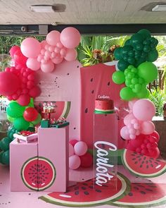 balloons and watermelon are on display at a party