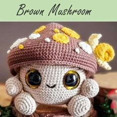 a crocheted stuffed animal wearing a hat with flowers on it's head