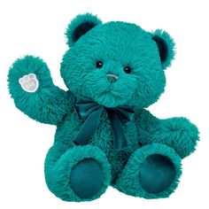 a blue teddy bear with a heart on it's chest and one paw in the air