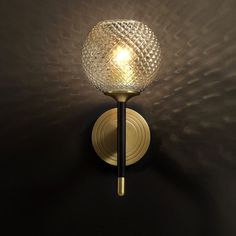 a light that is on the side of a wall with a glass ball in it