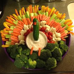 a platter filled with vegetables and dip