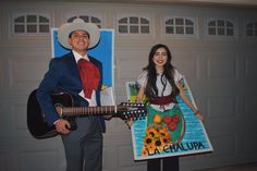 a man and woman are dressed up in costumes for the occasion, including a guitar