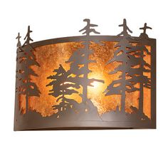 a light fixture with trees and birds on it