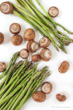 asparagus and mushrooms on a white surface