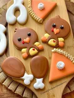 some decorated cookies are on a wooden tray