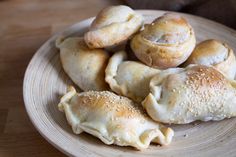 several pastries on a plate with sesame seeds