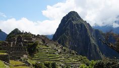 the ruins at machaca picach are surrounded by mountains