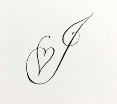 the letter v is made up of black ink and has a small heart on it