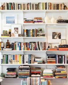 a bookshelf filled with lots of books and pictures on it's sides