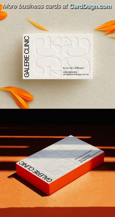 an orange and white business card sitting on top of a table