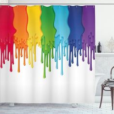 a rainbow shower curtain with dripping paint on the bottom and bottom, in front of a bath tub