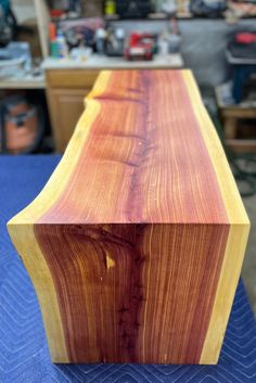 a wooden bench sitting on top of a blue table