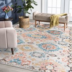 a living room area with blue walls and rugs on the floor, two couches and one chair