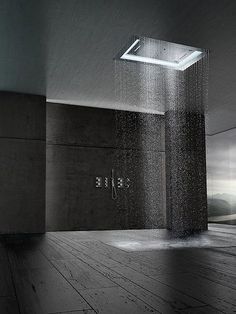 a shower head in the middle of a room with water coming from it's sides