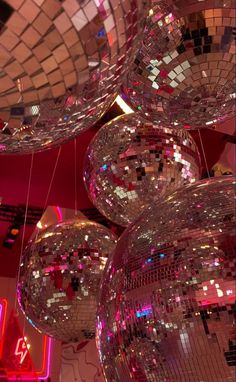 several shiny disco balls hanging from the ceiling