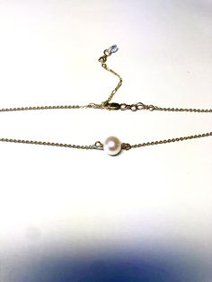 Stunning and made by hand with a real freshwater pearl in ivory white and adorned with Swarovski rhinestone rondelles and Swarovski AB crystals. Made with pure sterling Silver or 14K gold fill chain, with no open jump rings, ensuring strength and durability.Made 14” with 2" adjustable clasp, to be worn for layering at different lengths and Swarovski dangle down the back. Gold filled metal is highly superior to "gold plated" as it is non-tarnish, can be worn in water, and is hypoallergenic. Dainty Single Strand Akoya Pearl Jewelry, Adjustable Akoya Pearl Drop Jewelry, White Hypoallergenic Akoya Pearl Jewelry, Rondelle Pearl Chain Jewelry As Gift, Dainty Adjustable Pearl Necklace For Anniversary, Gold Rondelle Pearl Necklace As Gift, Pearl Jewelry Rondelle Shape For Gift, Pearl White Rondelle Jewelry With Pearl Drop, Single Strand Akoya Pearl Jewelry In Gold