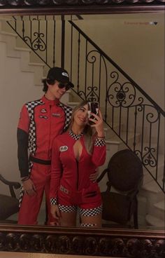 a man and woman dressed in racing outfits taking a selfie