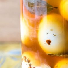 a jar filled with oranges sitting on top of a table