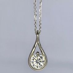 "This is a  moissanite pendant necklace that can be set in 14k white or yellow gold. The round moissanite infinity charm necklace is great for  layering or stacking, The teardrop pendant necklace is a dainty necklace great for anniversary, birthday, bridesmaid gift ideas.  The pendant pictured is a round moissanite #8026 -Approximate total carat weight:  approx. 0.50ctw diamond equivalent  -Center Stone Size: 5mm - approx. 0.50ct diamond equivalent -Center Stone Shape: round -Gem Type:  Zonar Mo Sterling Silver Teardrop Necklace With Bezel Setting, Silver Solitaire Necklace In Teardrop Shape, Dainty Silver Teardrop Diamond Necklace, Elegant Hypoallergenic Teardrop Pendant Necklace, White Gold Sterling Silver Solitaire Teardrop Pendant Necklace, Diamond White Teardrop Solitaire Necklace In Sterling Silver, Teardrop Solitaire Necklace In Diamond White, White Gold Teardrop Solitaire Necklace In Sterling Silver, Teardrop Diamond Cut Solitaire Necklace In Sterling Silver