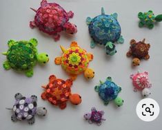 there are many different types of toy animals on the white surface, including one turtle and two sea turtles