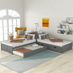 a living room filled with lots of furniture and decor on top of a hard wood floor