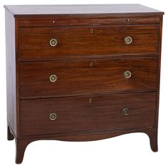 an antique chest of drawers with brass pulls and knobs on the front, against a white background