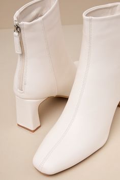 'Tis the season for falling leaves, cozy cardigans, and the Lulus Oceane Off White Ankle Booties! Smooth faux leather shapes these wardrobe-essential booties with a squared, pointed-toe upper and a seamed design. The ankle-high shaft boasts a 4.25"" pull-tab zipper at the heel for easy on-and-off, all atop a stylish blade heel. Available in whole sizes only. 2. 75" wrapped blade heel. Cushioned insole. Rubber sole has nonskid markings. Man Made Materials. Imported. Lulus | Oceane Off White Ankle Pointed Toe Mid-calf Boots With Stacked Heel For Fall, Fall Mid-calf Boots With Stacked Heel And Pointed Toe, Wide Calf Heeled Boots For Fall, Fitted Heeled Boots With Zipper For Winter, Fitted Winter Heeled Boots With Zipper Closure, Fitted Winter Boots With Zipper Closure, Fall Heeled Boots With Stacked Heel And Pointed Toe, Ankle-high Faux Leather Boots For Fall, Ankle-high Faux Leather Fall Boots