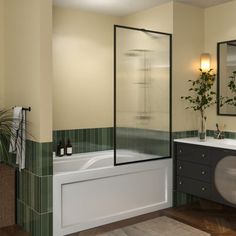 a bathroom with two sinks and a bathtub next to a mirror on the wall