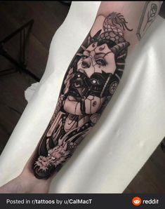 a man's arm with a black and white tattoo design on the left forearm