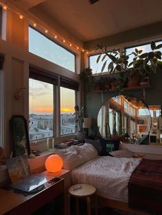 a bedroom with a large window overlooking the city