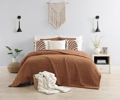 a bed with brown and white comforters in a bedroom