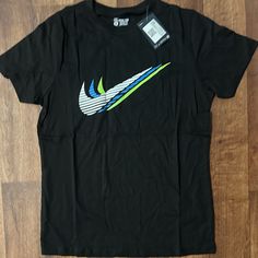 New With Tags Men's Standard Fit/Athletic Cut Black/Multi Color Swoosh Short Sleeve Black Dri-fit Tops For Streetwear, Casual Dri-fit T-shirt For Sports Season, Casual Dri-fit T-shirt For Sports Events, Sportswear Dri-fit T-shirt With Graphic Print, Nike Casual Dri-fit T-shirt, Casual Nike Dri-fit T-shirt, Sporty Dri-fit T-shirt For Streetwear, Casual Dri-fit Tops With Graphic Print, Sporty Streetwear T-shirt In Dri-fit Material