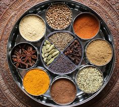 a metal tray filled with different types of spices