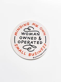 a white sticker with an orange and black writing on it that says, finding my own woman owned & operated small business