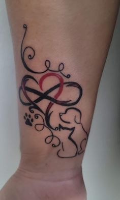 a woman's foot with a tattoo design on the side of her leg that has an elephant and heart in it